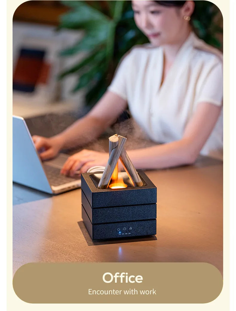 Bonfire Flame Aroma Diffuser on a work desk beside a laptop