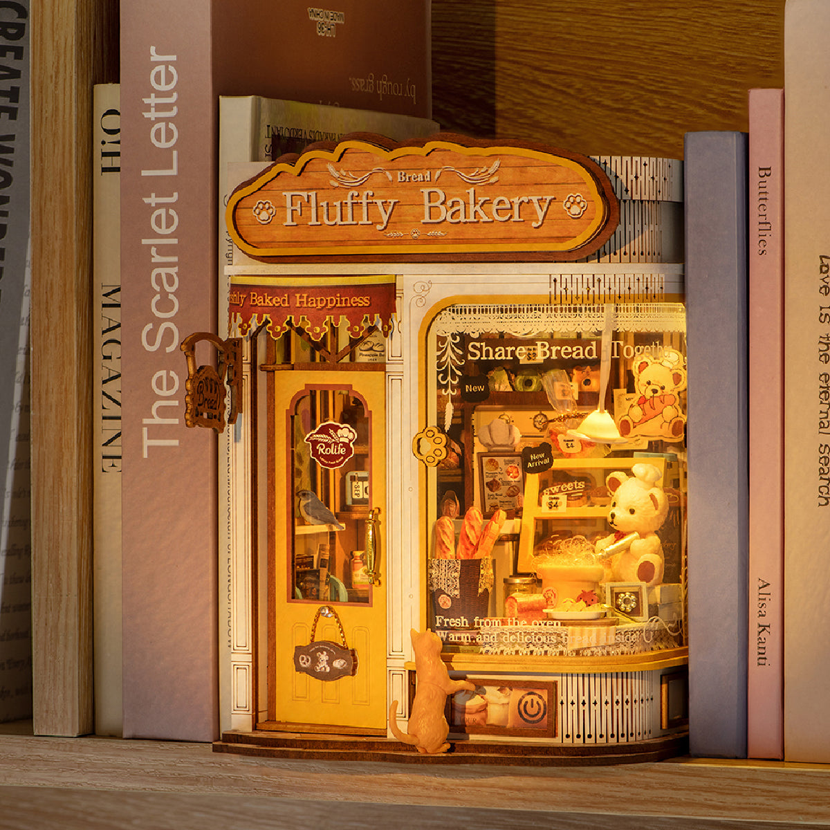 Illuminated Fluffy Bakery book nook on a bookshelf