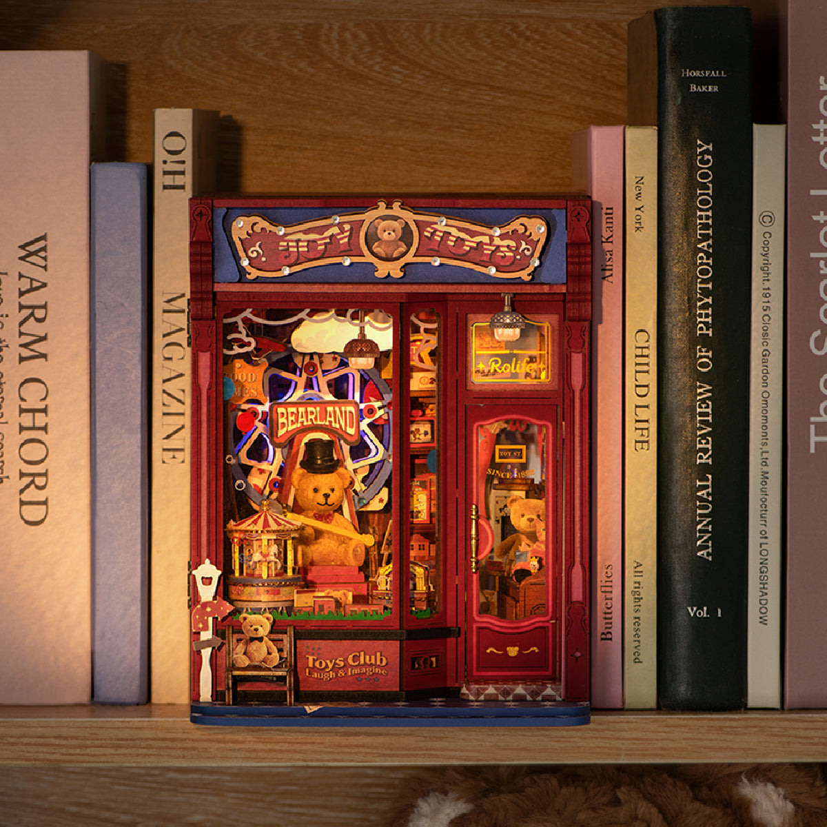 Illuminated Joy Toys book nook on a bookshelf