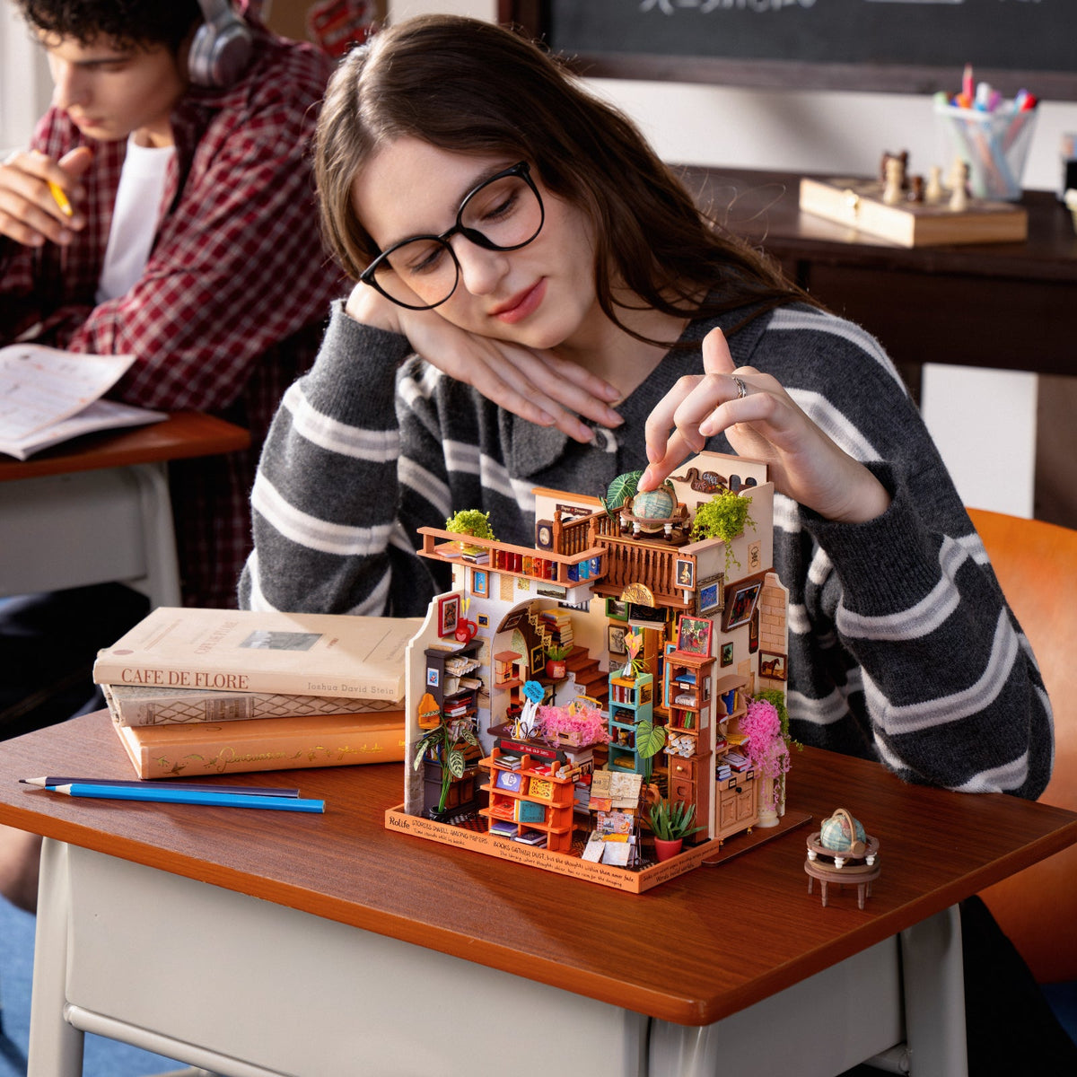 Builder adding details to the Pagestory Books miniature